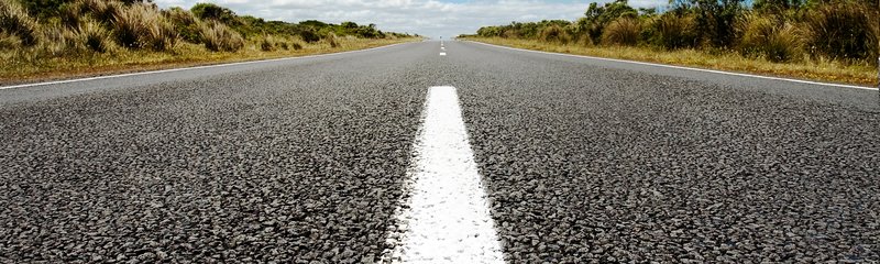 vertical-shot-asphalt-road-blue-sky